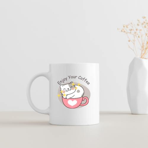 Cute white coffee mug with a smiling cat sitting in a pink heart cup and text Enjoy Your Coffee.